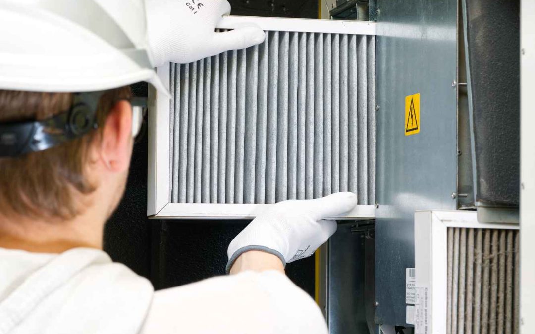 man checking furnace filter as part of hvac checklist